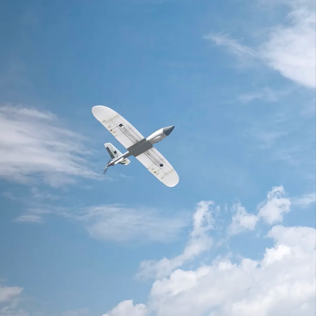 Military drone in flight over operational terrain